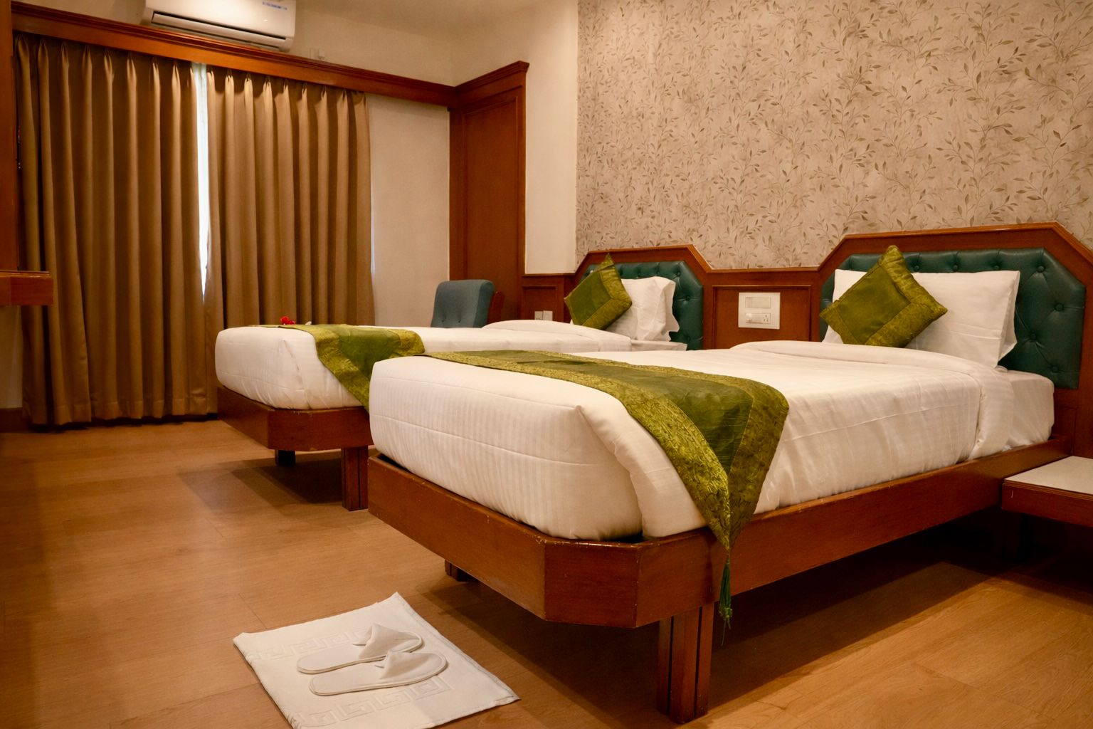 Deluxe Room — comfortable bed with elegant décor